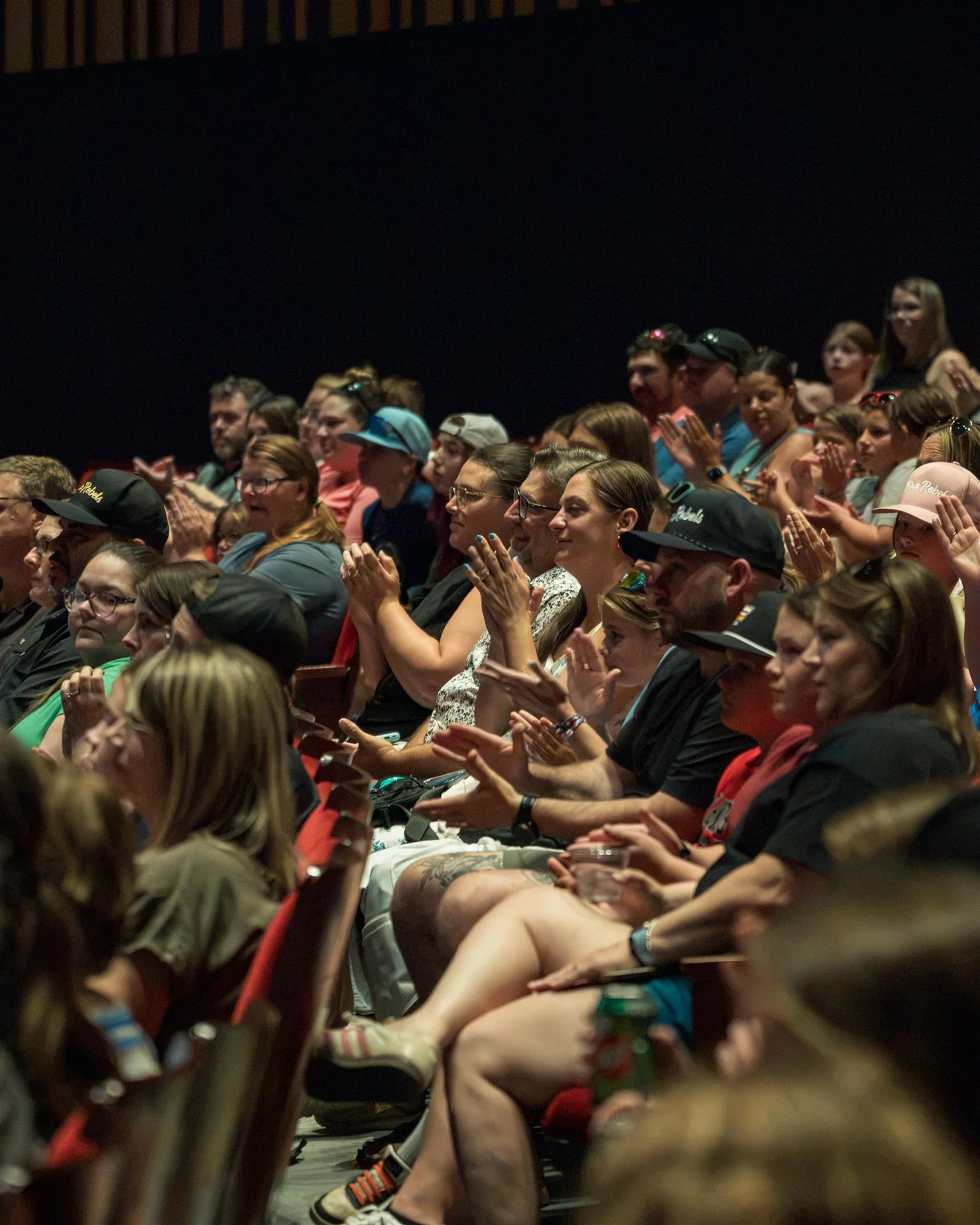 Players, families, and community members applauding at the Fredericton Playhouse